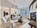 Inviting living room with a cozy fireplace, large windows, vaulted ceilings and an adjacent kitchen at 1020 S Ammons Cir, Lakewood, CO 80226