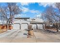 Charming two-story home featuring a three-car garage, well-kept lawn, and traditional American flag at 12680 Forest Dr, Thornton, CO 80241