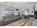 Spacious living room with ample natural light, a large couch, and an attached dining area at 12680 Forest Dr, Thornton, CO 80241