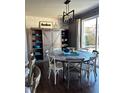Charming dining room featuring a round table, elegant lighting, and ample natural light at 3173 Youngheart Way, Castle Rock, CO 80109