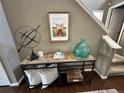 Stylish entryway table with decorative items and a framed picture adding charm to the home's interior at 3173 Youngheart Way, Castle Rock, CO 80109