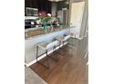 Modern kitchen island with granite countertops and bar stool seating, ideal for casual dining at 3173 Youngheart Way, Castle Rock, CO 80109