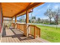Covered front porch showcasing stone pillars and a stained wood ceiling at 5365 Eldridge St, Arvada, CO 80002