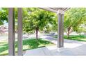View from the front porch looking out onto a tree-lined street with green lawns at 19730 E 58Th Pl, Aurora, CO 80019
