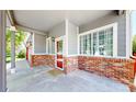 Covered front porch with brick accents, view of front door, and large picture window at 19730 E 58Th Pl, Aurora, CO 80019