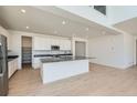 Modern open-concept kitchen featuring an island, stainless steel appliances, and ample cabinet space at 4599 Windmill Dr, Brighton, CO 80601