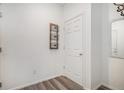 Simple entryway with white walls, wood-look floors, and a coat closet at 11425 Booth Falls Ct, Parker, CO 80134