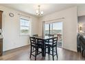Bright dining area with a table, chairs, and a sliding glass door leading to the backyard at 4992 Trails Edge Ln, Castle Rock, CO 80104