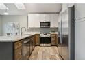 Bright kitchen featuring stainless steel appliances, granite countertops, and skylights at 6425 Nassau Ct, Highlands Ranch, CO 80130