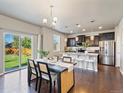 Dining area with table, chairs, pendant light, and a sliding glass door to the backyard at 1181 W 170 Th Ave, Broomfield, CO 80023