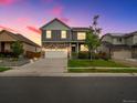 Two-story house with gray siding, stone accents, and a landscaped yard at 1181 W 170 Th Ave, Broomfield, CO 80023