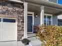 Home exterior showing stone and siding accents, two-car garage, and covered front entry at 1181 W 170 Th Ave, Broomfield, CO 80023