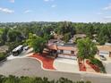 An elevated daytime view shows the beautiful landscaping surrounding this property at 8233 W 62Nd Pl, Arvada, CO 80004