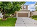 Charming two-story home with a well-maintained lawn, landscaping, and attached two-car garage at 2905 S Deframe Way, Lakewood, CO 80228