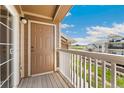 Balcony shows railing and door leading to views of nearby residences and a bright sky at 7440 S Blackhawk St # 7-303, Englewood, CO 80112