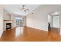 Bright living room features a fireplace, hardwood floors, and sliding glass doors to balcony at 7440 S Blackhawk St # 7-303, Englewood, CO 80112