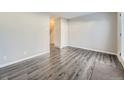 Bright living room featuring gray wood-look flooring and neutral paint throughout at 14006 E Utah Cir, Aurora, CO 80012