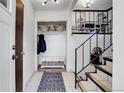 Bright entryway with coat closet, bench, and staircase at 16193 E Dickenson Pl, Aurora, CO 80013