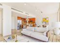 Open-concept living area with modern furnishings and stainless steel appliances at 1201 N Williams St # 3B, Denver, CO 80218