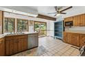 Charming kitchen with tile flooring, wooden cabinets, and a bright window overlooking the backyard at 1037 Wagonwheel Gap Rd, Boulder, CO 80302