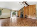 Spacious living room featuring hardwood floors, a stone fireplace, and a walkout deck at 1037 Wagonwheel Gap Rd, Boulder, CO 80302