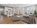 Bright, open living space with hardwood floors, neutral decor, and modern furniture at 27639 E 7Th Ln, Aurora, CO 80018