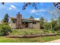 Charming single-Gathering home features a stone chimney and awning-covered porch at 1275 Niagara St, Denver, CO 80220