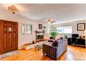 Comfortable living room with hardwood floors, fireplace, and ample natural light at 1275 Niagara St, Denver, CO 80220