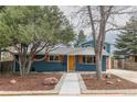 Charming two-story home with blue siding, orange shutters, manicured yard, and inviting curb appeal at 1120 Hartford Dr, Boulder, CO 80305