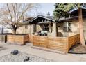Charming brick home with a wooden fence and quaint porch seating area under an inviting covered entrance at 2909 Newton St, Denver, CO 80211