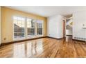 Bright living room with hardwood floors and large windows at 8962 Sunset Ridge Ct, Highlands Ranch, CO 80126