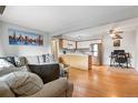 Bright living room and kitchen with hardwood floors, modern appliances, and a spacious layout at 3663 S Sheridan Blvd # O15, Denver, CO 80235