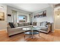 Comfortable living room featuring a large sectional sofa, glass coffee table, and bright natural light at 3663 S Sheridan Blvd # O15, Denver, CO 80235