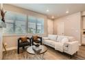 Inviting living room with neutral tones, comfortable seating, large windows, and modern decor at 9769 E 62Nd Dr, Denver, CO 80238