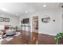 Spacious living room featuring hardwood floors, a comfortable sofa, and a console table with stylish decor at 3541 E 118Th Ave, Thornton, CO 80233