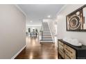 Elegant foyer featuring hardwood floors, a staircase, and an open view to the dining and living areas at 172 S Forest St, Denver, CO 80246