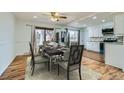 Dining area next to kitchen features wood floors, and a stylish dining set at 8471 Rainbow Ave, Denver, CO 80229