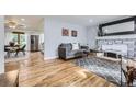 Inviting living room featuring hardwood floors, fireplace, and open layout at 8471 Rainbow Ave, Denver, CO 80229