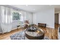 Bright living room with a large window, hardwood floors, and neutral decor at 8471 Rainbow Ave, Denver, CO 80229