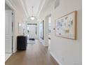 Elegant foyer with hardwood floors, tray ceilings, and stylish decor at 13633 Mariposa St, Broomfield, CO 80023