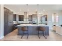 This gourmet kitchen includes an oversized island, modern backsplash, sleek countertops, and stainless steel appliances at 307 W Charles St, Superior, CO 80027