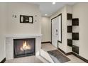 Bright entryway with fireplace, built-in shelving, and hardwood floors at 12644 W Virginia Ave, Lakewood, CO 80228