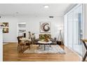 Bright and airy living room featuring hardwood floors, a cozy rug, and stylish contemporary furnishings at 1861 Mallard Dr, Superior, CO 80027