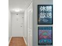 Hallway showcasing tiled floors, white doors and light fixture, and two pieces of artwork decorating the wall at 1155 N Ash St # 102, Denver, CO 80220