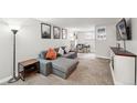 Comfortable living room with sectional sofa, neutral decor, modern shelving and desk area with natural light at 1155 N Ash St # 102, Denver, CO 80220