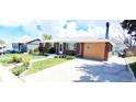 A charming brick home with well-maintained lawn and concrete driveway at 8338 Charles Way, Denver, CO 80221