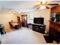 Cozy living room featuring a fireplace, dining area, and neutral carpeting at 8338 Charles Way, Denver, CO 80221