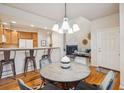 Open dining area with seating for four, flowing seamlessly from the kitchen and living room at 12827 W Burgundy Pl, Littleton, CO 80127
