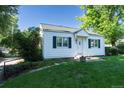 Charming home with a well-manicured lawn and mature trees at 5680 W 41St Ave, Wheat Ridge, CO 80212