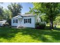 Charming home with a well-manicured lawn and mature trees at 5680 W 41St Ave, Wheat Ridge, CO 80212